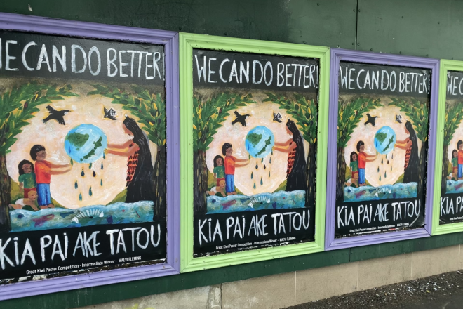 Photograph of a line of identical, colorful posters with the text "We Can Do Better! Kia Pai Ake Tatou"